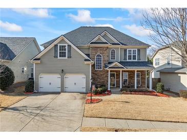 Traditional two-story home with stone accents, attached two car garage, and landscaped front yard at 540 Roland Manor Dr, Dacula, GA 30019