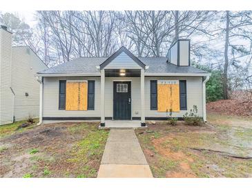 Charming home featuring a gray exterior, black shutters and a well-maintained lawn at 2370 Wingfoot Pl, Decatur, GA 30035