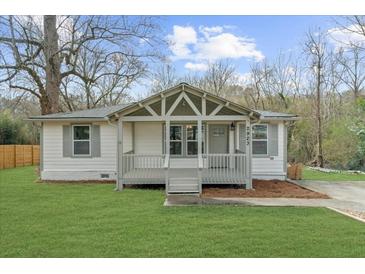 Charming home featuring a covered front porch, manicured lawn, and neutral exterior color scheme at 2923 Hall Se Dr, Smyrna, GA 30082