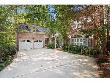 Charming brick home with a two-car garage and lush landscaping at 4470 Crestwicke Pointe, Atlanta, GA 30319