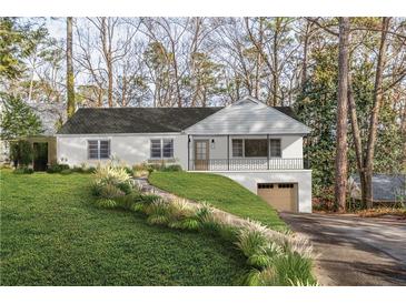 Charming home featuring a stone walkway, covered porch, and a drive under garage at 4103 Statewood Ne Rd, Atlanta, GA 30342