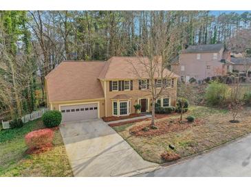 Charming two-story home featuring a well-maintained lawn, two-car garage, and lovely curb appeal at 1429 Christiana Dr, Lawrenceville, GA 30043