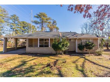 Charming brick home featuring a covered carport and a well-maintained front yard with mature trees at 3517 Hyland Dr, Decatur, GA 30032