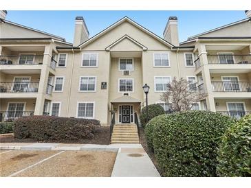 Exterior of multi-story building with a beige facade, multiple windows, and trimmed hedges at 3655 Habersham Ne Rd # 111, Atlanta, GA 30305