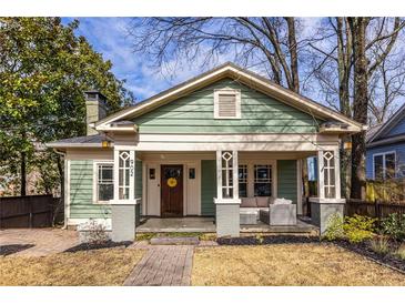 Charming green craftsman-style home with inviting front porch and brick pathway at 902 E Ponce De Leon Ave, Decatur, GA 30030