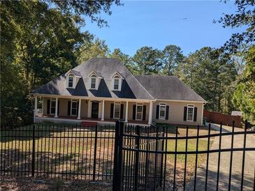 Charming single-Gathering home featuring a quaint porch and traditional architectural details at 4401 Riverlake Way, Snellville, GA 30039
