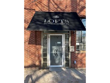 Building entrance with awning showing address in brick building, great location at 172 Haynes Sw St # 102, Atlanta, GA 30313