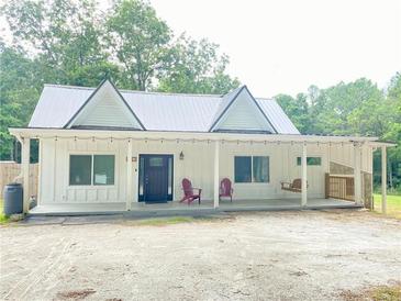 Charming home with a covered porch and metal roof at 4267 Klondike Rd, Lithonia, GA 30038