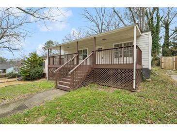 Inviting home with a charming covered front porch and nicely landscaped front yard at 214 Maple St, Atlanta, GA 30354
