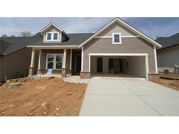 New construction home featuring a covered porch with brick accents and an attached two-car garage at 2017 Ripple Park Bnd, Canton, GA 30114