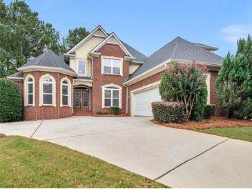 Beautiful brick two-story home with mature landscaping and an extended driveway at 1258 Mcallistar Dr, Locust Grove, GA 30248