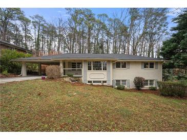 Charming brick ranch-style home with a covered carport and lush, mature landscaping at 2151 Zelda Ne Dr, Atlanta, GA 30345