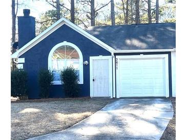 Charming home featuring a chimney, arched window, and a one-car garage at 3611 Spring Pt, Decatur, GA 30034