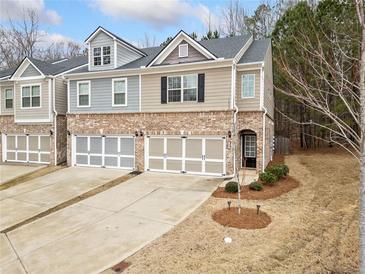 Charming townhome with brick accents, attached two-car garage, and well-maintained landscaping at 96 Trailview Lane Ln, Hiram, GA 30141