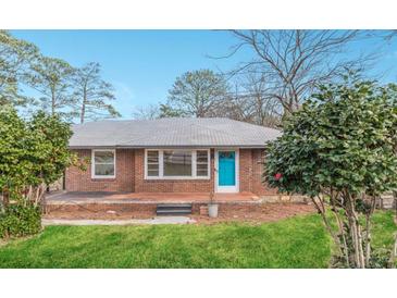 Charming brick home with a well-manicured lawn and bright blue front door at 4624 College St, Forest Park, GA 30297