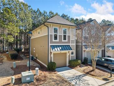 Charming two-story home with neutral siding, well-kept landscaping, and a one car garage at 507 Ridge View Xing, Woodstock, GA 30188