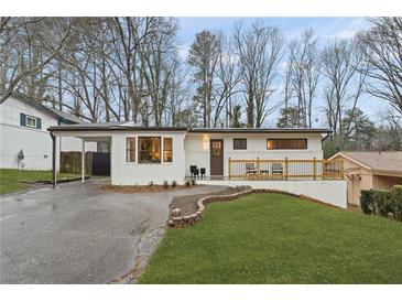 Charming renovated home with an inviting front yard, carport, and small front deck at 2111 Drew Valley Ne Rd, Brookhaven, GA 30319