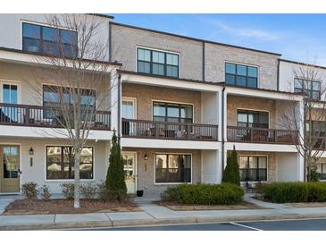 Charming townhome with brick facade, cozy balconies, and well-maintained landscaping at 127 Harlow Cir, Roswell, GA 30076