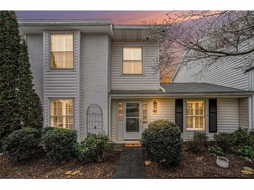 Charming two-story home featuring a painted brick facade, complemented by lush landscaping and a welcoming entrance at 1434 Hampton Glen Ct, Decatur, GA 30033