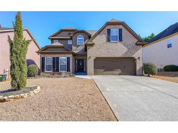 Charming two-story brick home with a well-manicured lawn and two car garage at 4972 Arbor View Nw Pkwy, Acworth, GA 30101