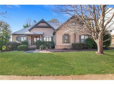 Charming home featuring manicured lawn, mature landscaping, and inviting front entrance at 772 Crescent Cir, Canton, GA 30115