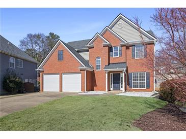 Charming two-story brick home with a well-manicured lawn and a two-car garage at 4525 Chelton Se Ct, Smyrna, GA 30080