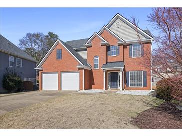 Charming two-story brick home with a well-manicured lawn and attached two-car garage at 4525 Chelton Se Ct, Smyrna, GA 30080