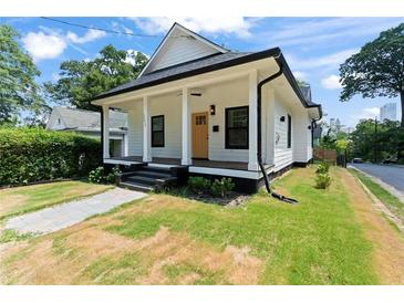 Beautiful home exterior with a covered porch and well-manicured lawn at 203 Sunset Nw Ave, Atlanta, GA 30314