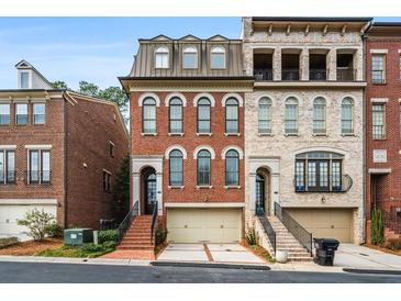 Charming brick townhome with attached garage and inviting front entrance with beautiful architectural detail at 3641 Broughton Se Cir, Atlanta, GA 30339