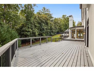 Spacious outdoor deck overlooking a lush green backyard, perfect for entertaining and relaxation at 725 Riley Pl, Sandy Springs, GA 30327