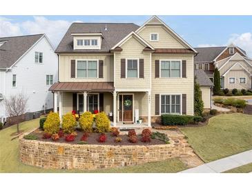 Charming two-story home with a manicured lawn and inviting front porch at 2601 Boulder Way, Woodstock, GA 30188