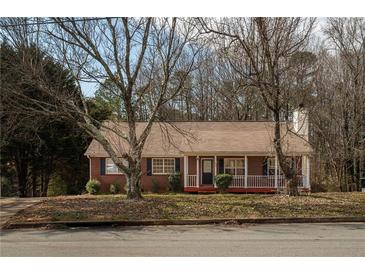 Charming brick home with inviting front porch and mature trees in a quiet neighborhood at 541 Exam Ct, Lawrenceville, GA 30044