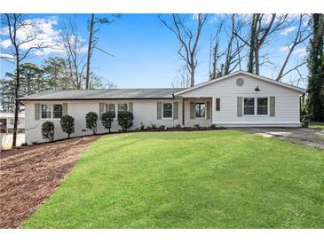 Charming home featuring a well-manicured lawn, neutral paint, and complemented by lush greenery and mature trees at 4770 Wayland Cir, Acworth, GA 30101