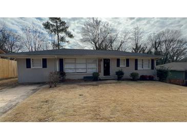 Charming single-story home with a well-maintained lawn and classic brick facade at 4027 Gladesworth Ln, Decatur, GA 30035