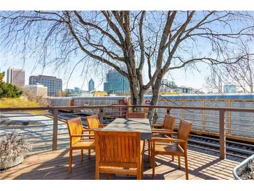Inviting outdoor deck with wooden table, chairs, and scenic city view, ideal for entertaining at 500 Means Nw St # F, Atlanta, GA 30318
