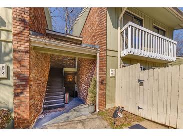Brick condo exterior showing private entrance and balcony at 702 Hanover Se Ln, Marietta, GA 30067