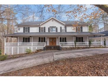 Charming two-story traditional home with inviting full length covered front porch and double door entrance at 1700 Bailey Creek Sw Rd, Conyers, GA 30094