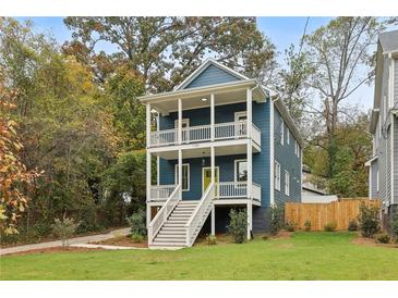 Charming two-story home boasts double porches, a blue facade, and a vibrant yellow front door at 1183 Mobile Nw St, Atlanta, GA 30314