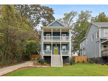 Charming two-story home with a welcoming front porch and professionally landscaped front yard at 1183 Mobile Nw St, Atlanta, GA 30314