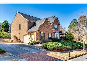 Charming brick home featuring an attached two-car garage and well-manicured front lawn at 3135 Preservation Cir, Lilburn, GA 30047