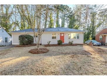 Charming one-story home with an orange front door, complemented by a well-maintained front yard at 2080 Dellwood Pl, Decatur, GA 30032