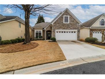 Charming home with stone accents, well-maintained yard, and a two-car garage offers curb appeal at 832 Chalet Hls, Mcdonough, GA 30253