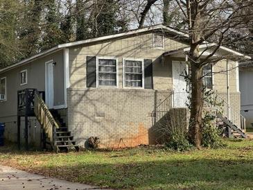 Charming single-story home featuring a brick foundation, complemented by a well-maintained yard at 1171 Wedgewood Nw Dr, Atlanta, GA 30318
