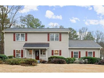 Charming two-story home with neutral siding, red shutters, and a well-manicured lawn at 1745 Pierce Arrow Pkwy, Tucker, GA 30084