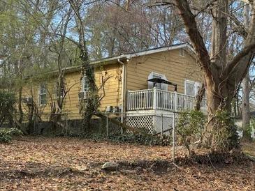 Cozy single-story house featuring a white fenced deck and a chain-link fenced yard at 474 Center Hill Nw Ave, Atlanta, GA 30318