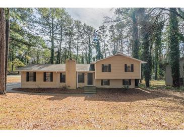 Traditional two-story home with brick chimney and mature trees at 3090 Chimney W Rdg, Snellville, GA 30078