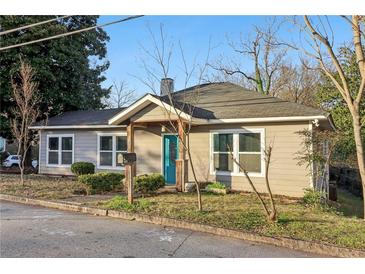 Charming single-story home with a light gray exterior, blue door, and well-maintained landscaping at 1268 Wylie Se St, Atlanta, GA 30317