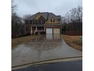 Traditional two-story brick home with a two-car garage and a large driveway at 1831 Nours Landing Way, Duluth, GA 30097