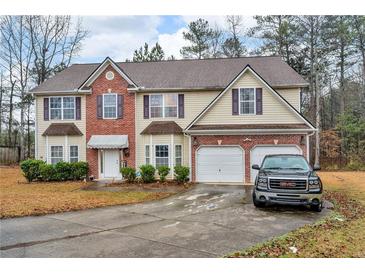 Charming two-story home with brick accents, attached two-car garage, and a well-maintained front yard at 8034 Bradshaw Ct, Douglasville, GA 30134