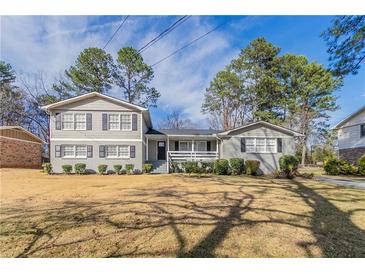 Charming gray home with black shutters and a manicured lawn in a residential neighborhood at 4124 Casa Loma Dr, Decatur, GA 30034